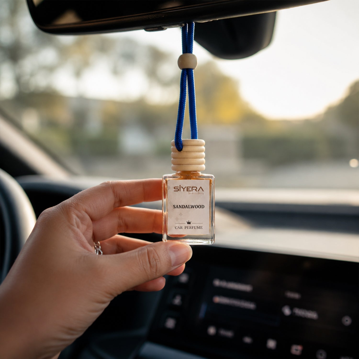 Close-up detail of the natural wooden cap on the Siyera Sandalwood Car Perfume bottle.