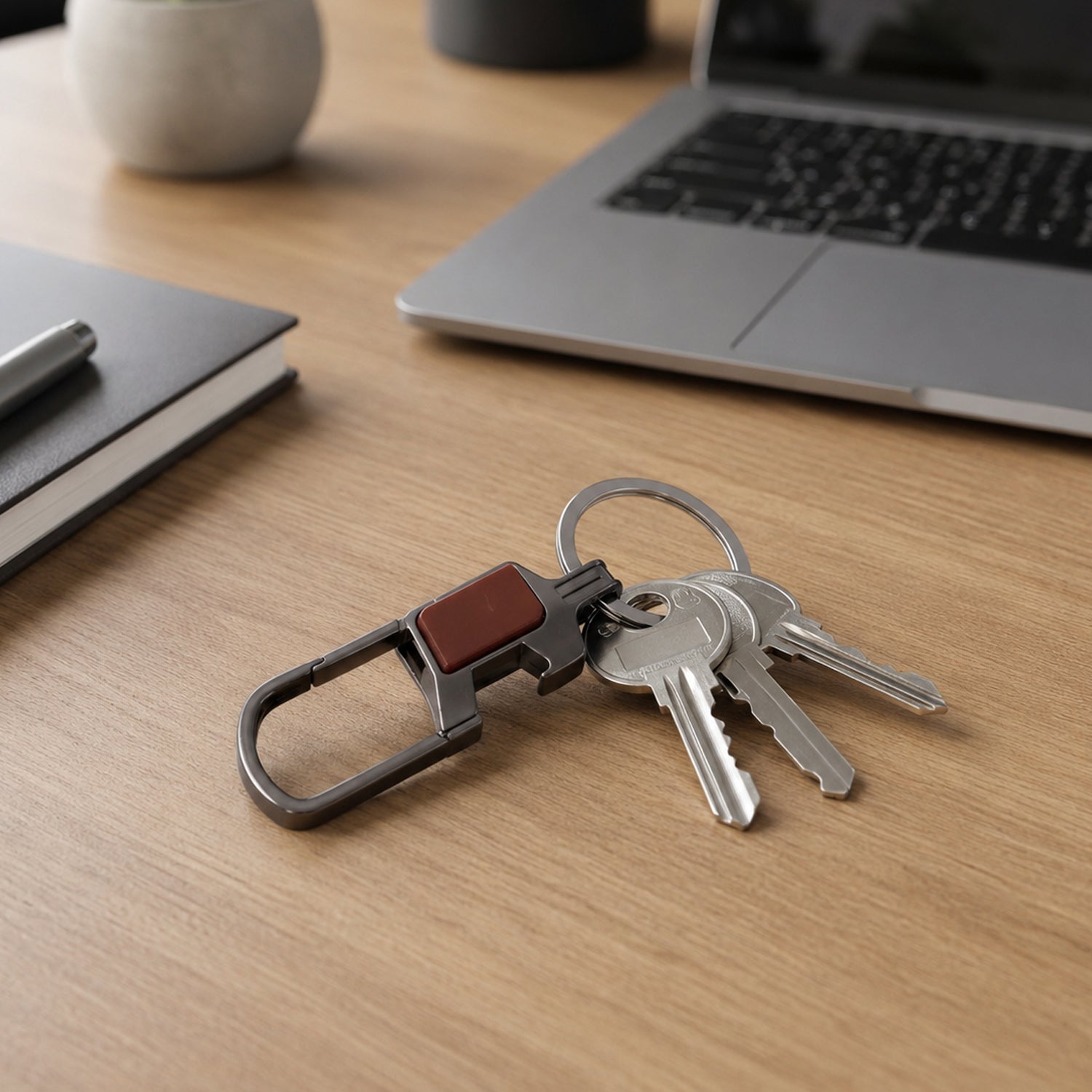 Metal key holder clipped onto a bag strap for easy carry