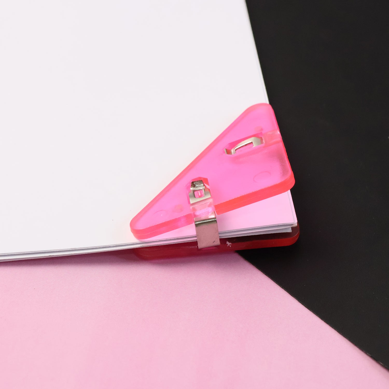 Close-up of triangle paper clip on paper corner