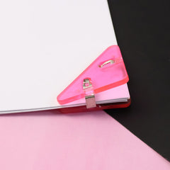 Close-up of triangle paper clip on paper corner