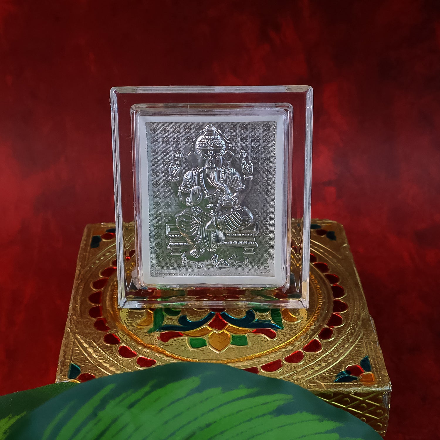 Sacred Silver Embossed Lord Ganesha Photo Frame displayed on an altar