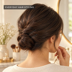 A white card displays four sets of black bobby pins against a plain white background.