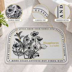 A half-round white mat with black floral print and a golden quote, with magnified details of the design and border.