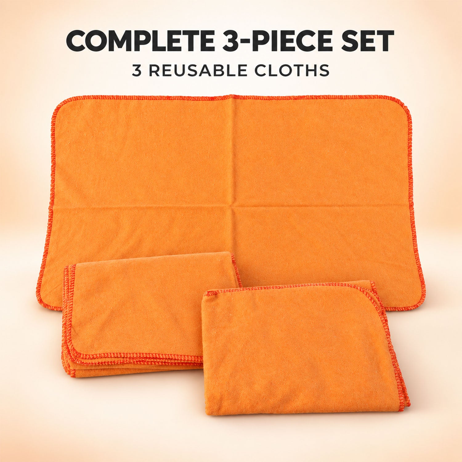A complete set of three orange reusable cleaning cloths, one unfolded and two folded, on a light background.