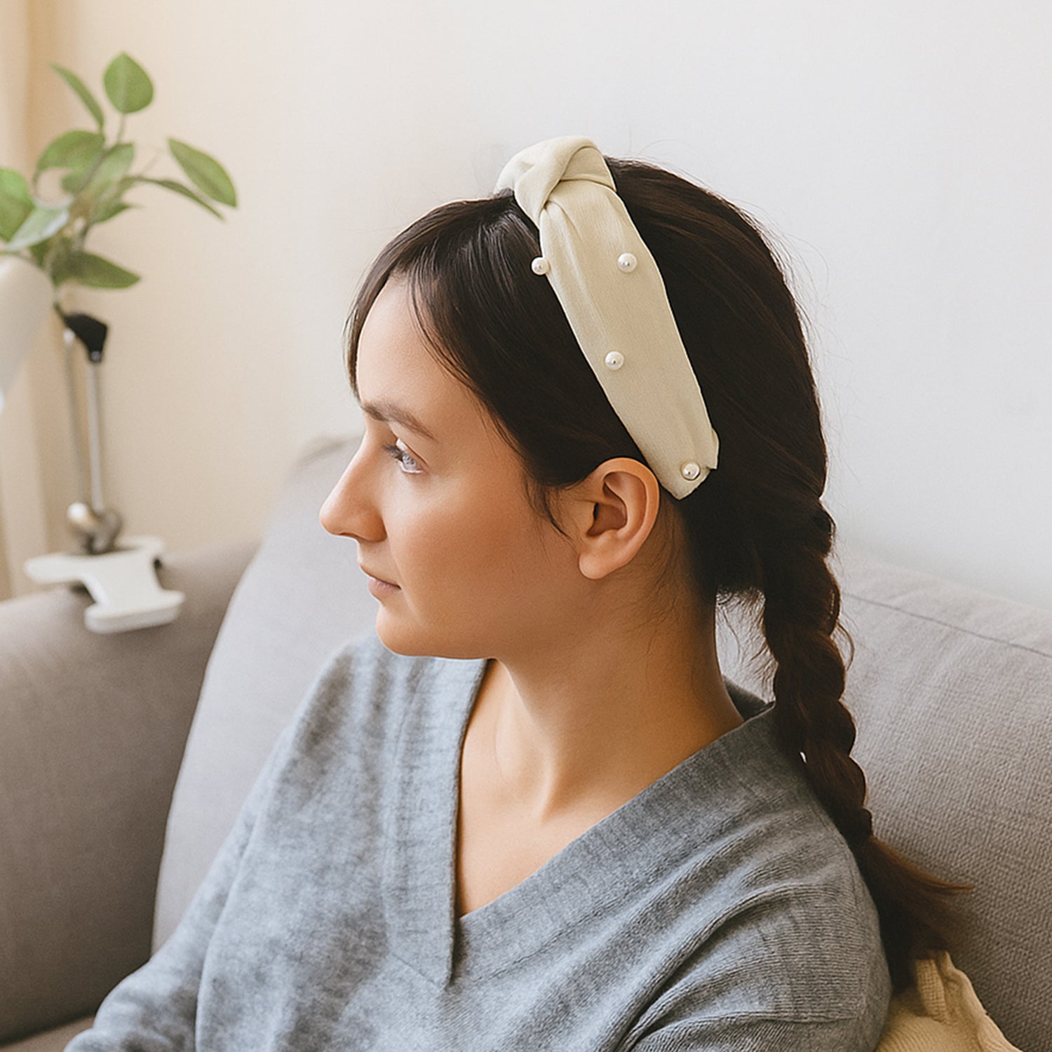 Woman wearing a stylish ribbed knot hairband, side view