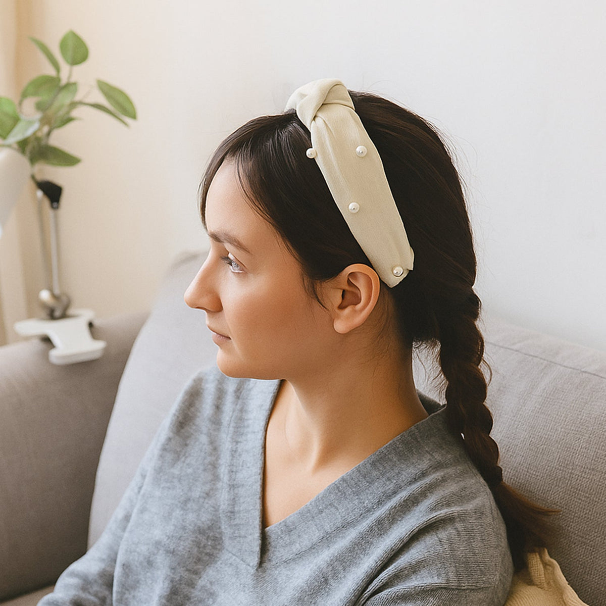 Woman wearing a stylish ribbed knot hairband, side view