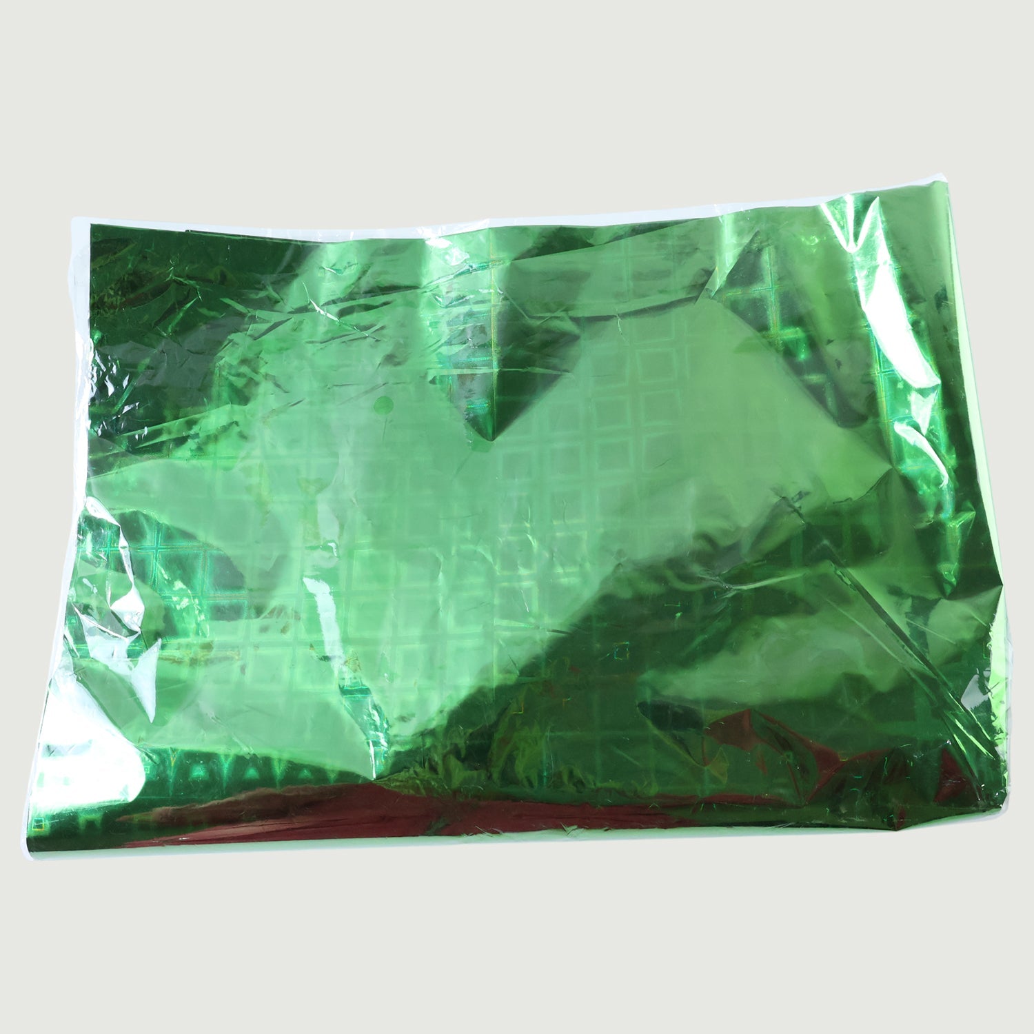 Person wrapping a gift with metallic star print paper