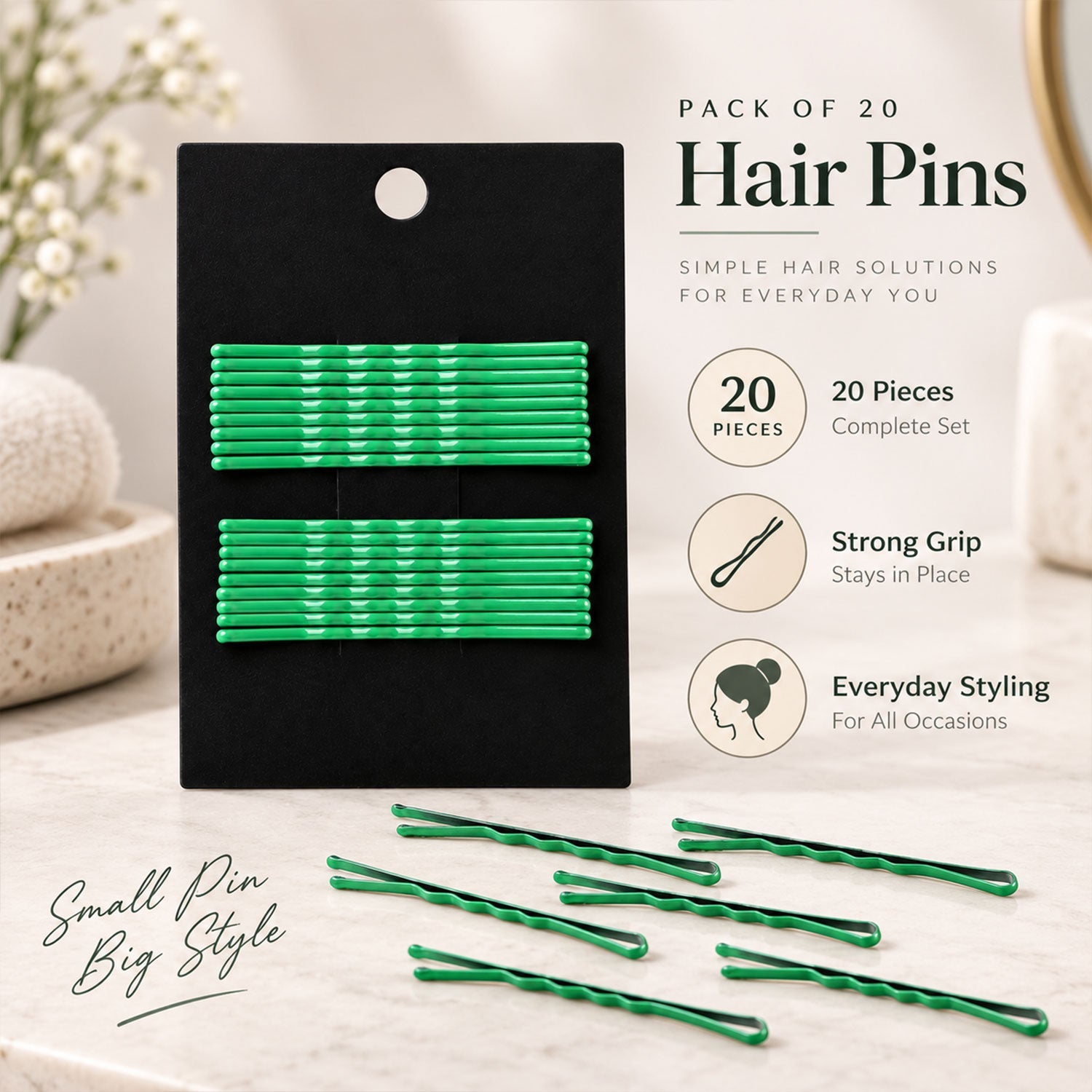 A black card of green metal bobby pins is displayed on a light surface with several loose pins scattered around, alongside