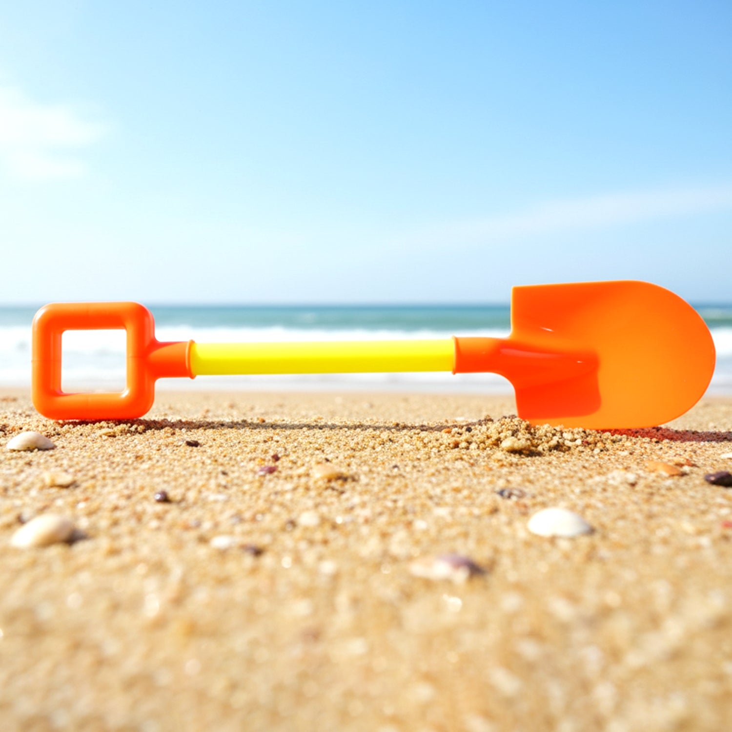 Kids shovel placed on garden sand surface