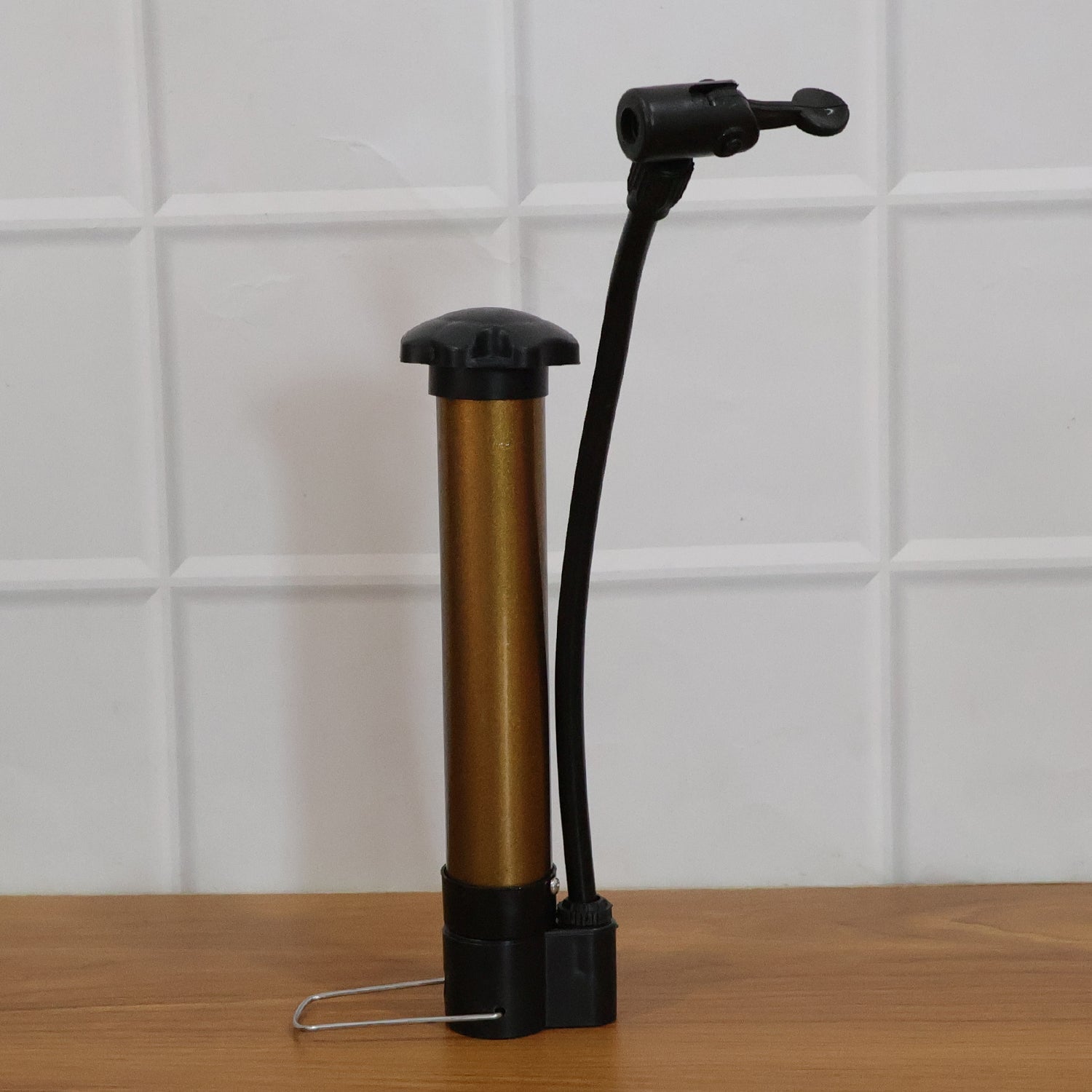 Mini hand air pump inflator side view with needle attached