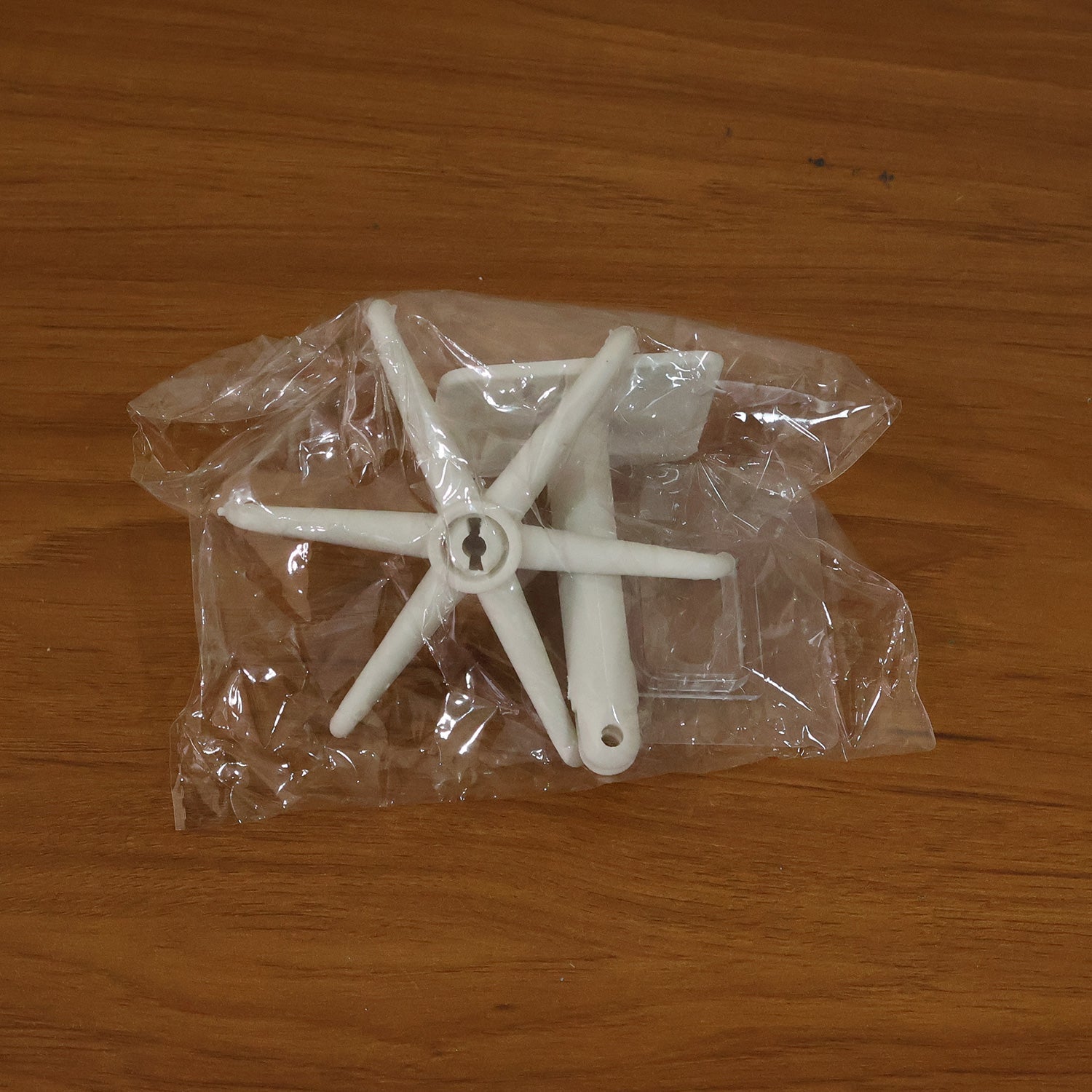Adhesive hook on glass surface holding miscellaneous items