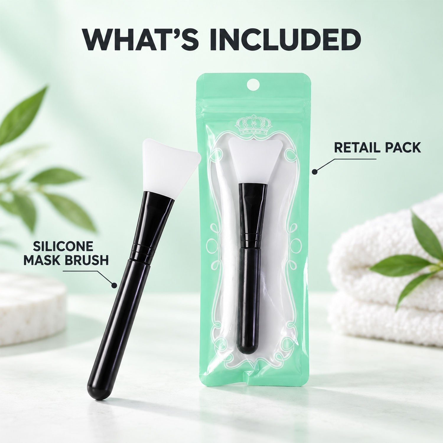 A black and white silicone mask brush stands next to its retail packaging, a clear plastic bag with a mint green backing, on