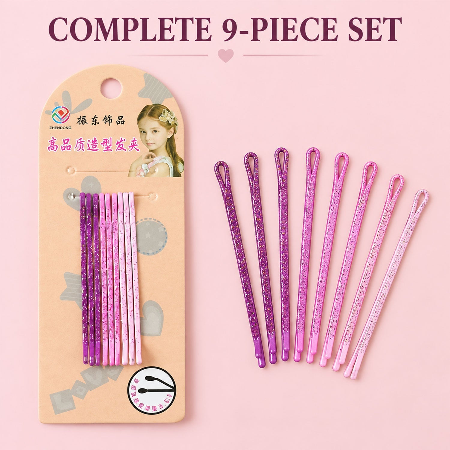 A complete set of nine glitter bobby pins, five purple and four pink, displayed next to their retail packaging.