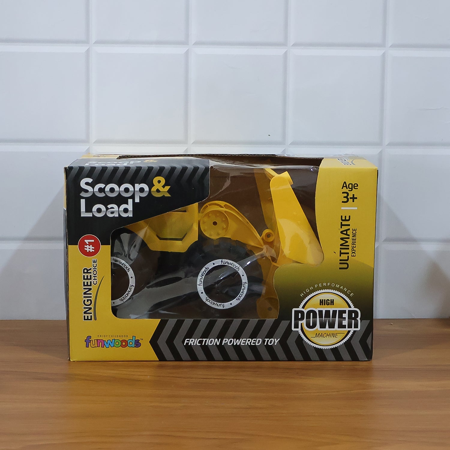 Side close-up of friction wheels on front loader toy