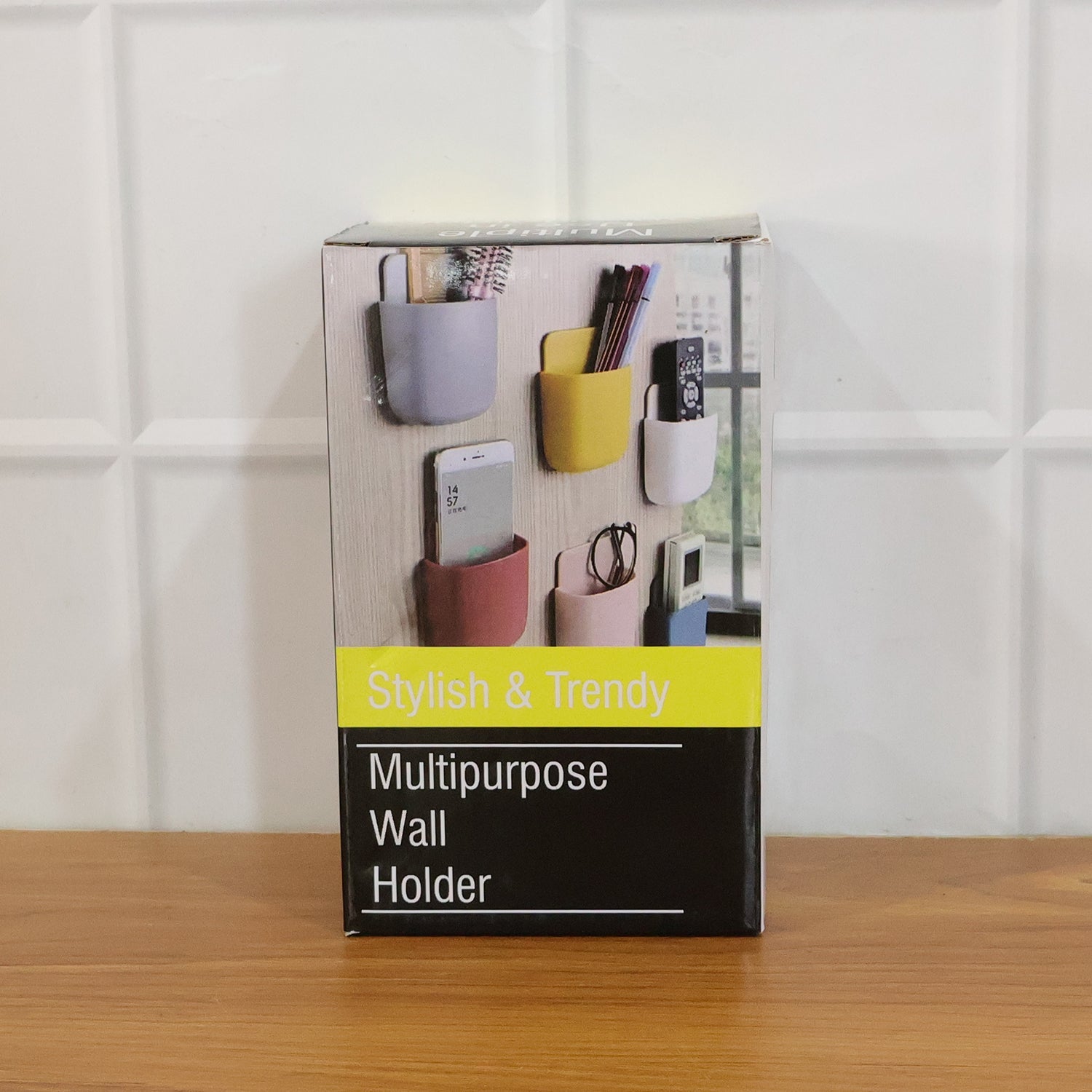 Set of four plastic wall holders in different colors mounted on stainless steel surface