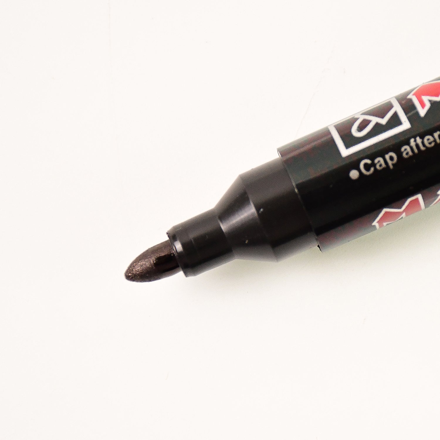 Black ink whiteboard marker showing its refillable tip
