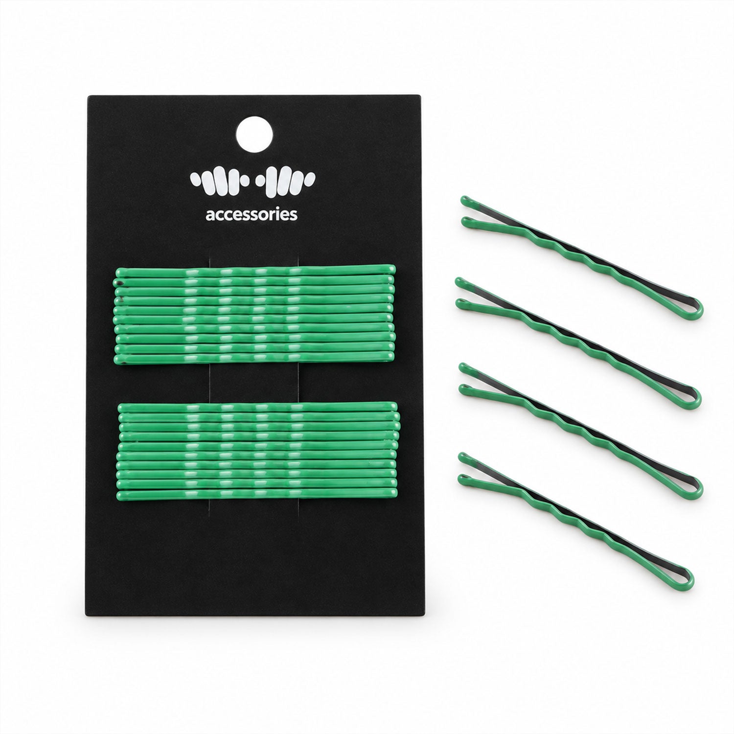 A black card with green metal bobby pins lies next to four individual green pins on a plain white background.