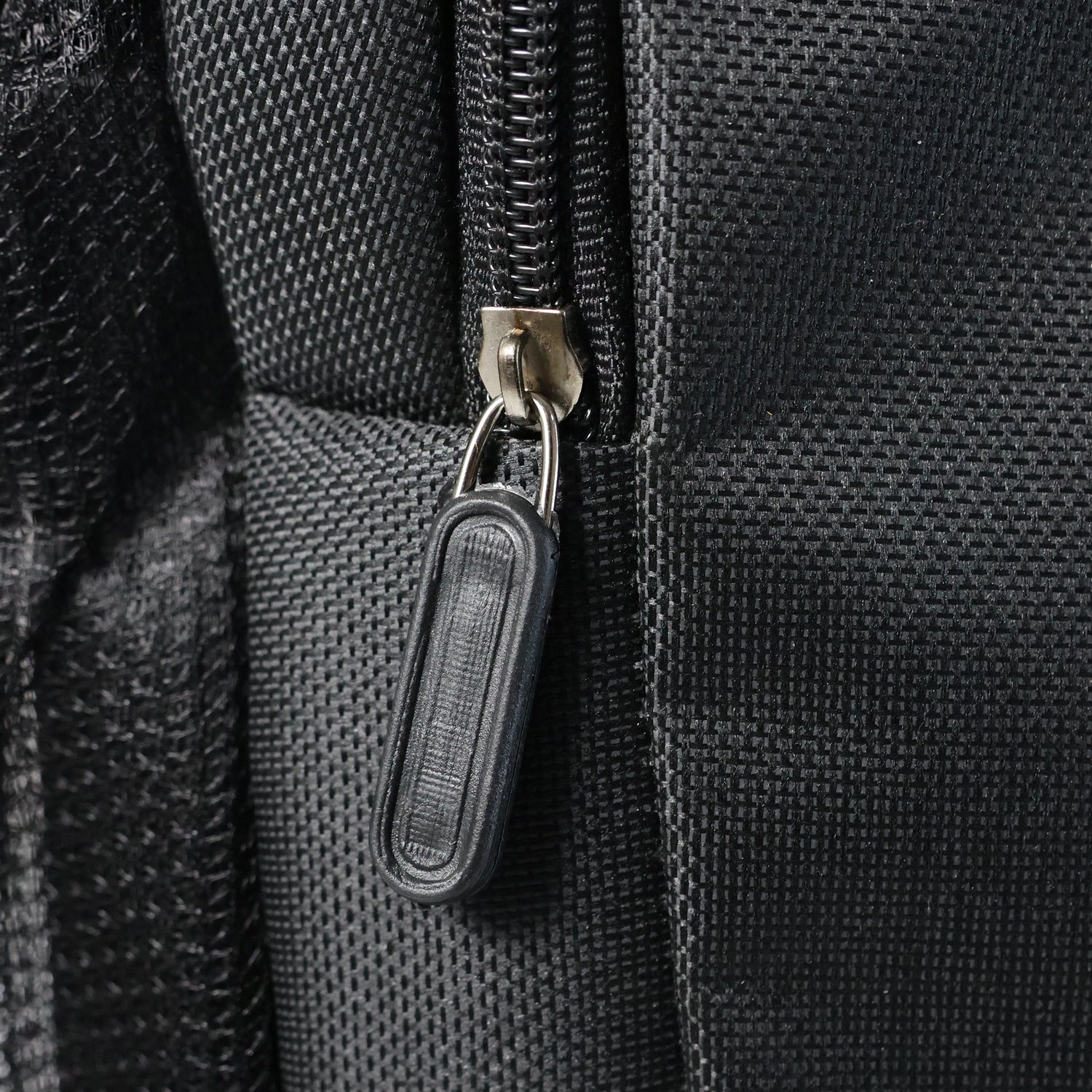 Adjustable carrying straps and zipped side pocket on backpack