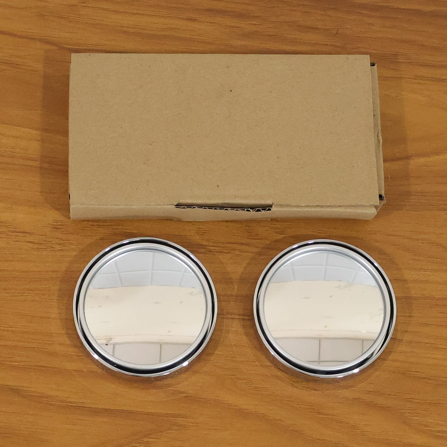 Installation of silver round blind spot mirror on car side mirror