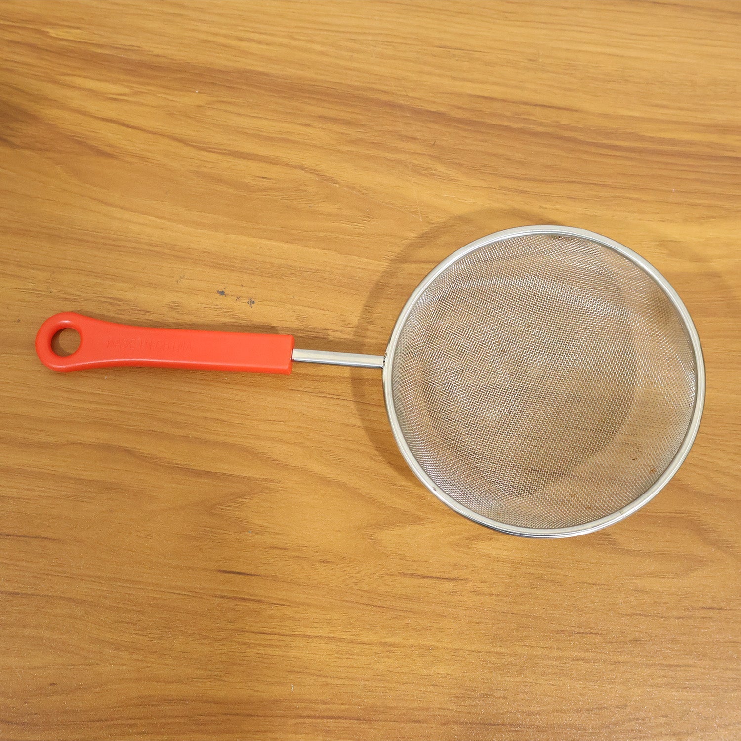 Kitchen strainer in use during cooking
