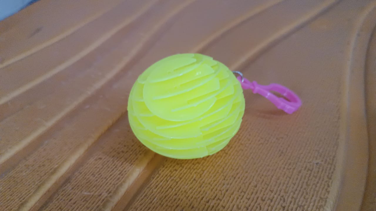 Worm fidget toy in flexible shapes on white surface