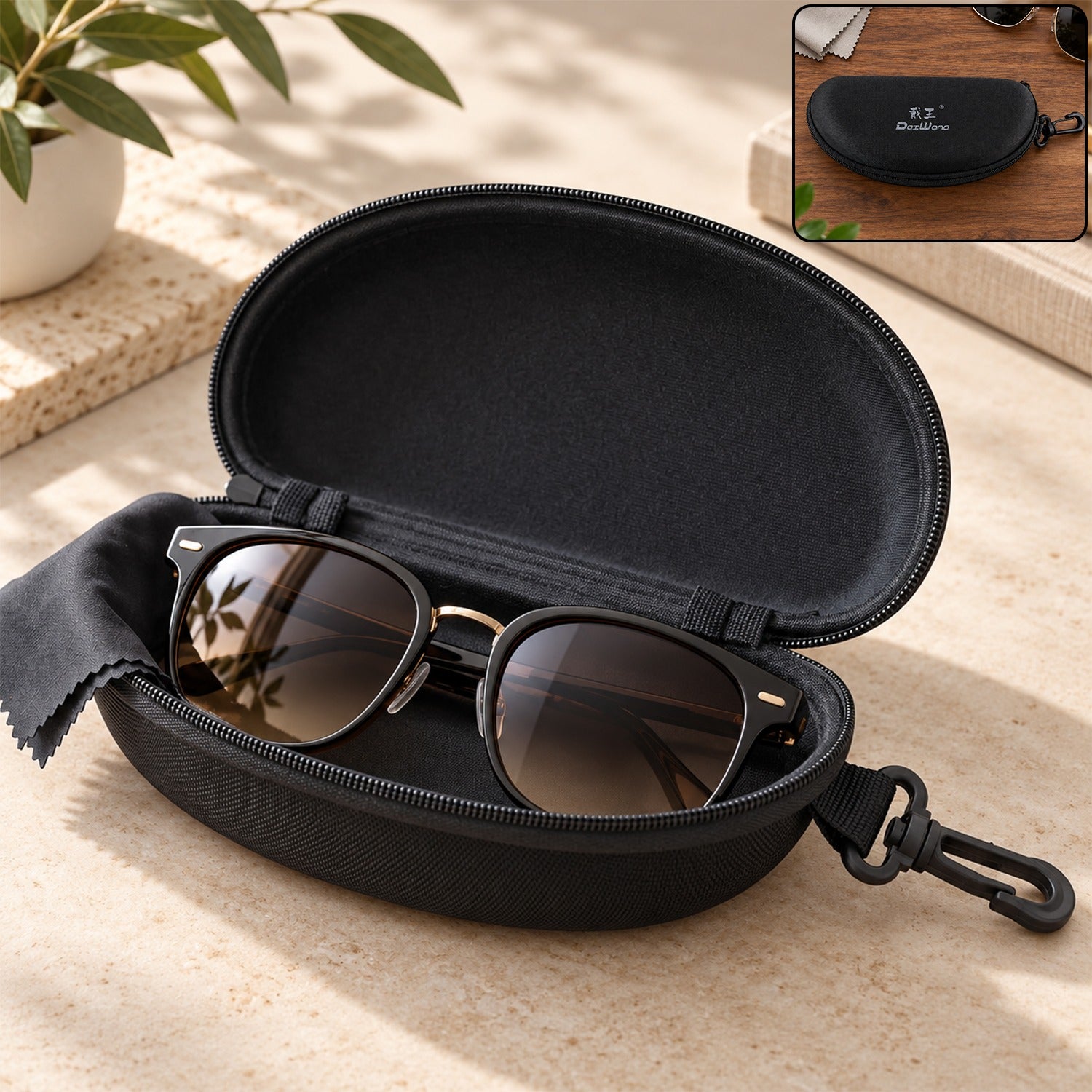 Open black hard shell sunglasses case with black sunglasses and cleaning cloth inside, on a light-colored surface.