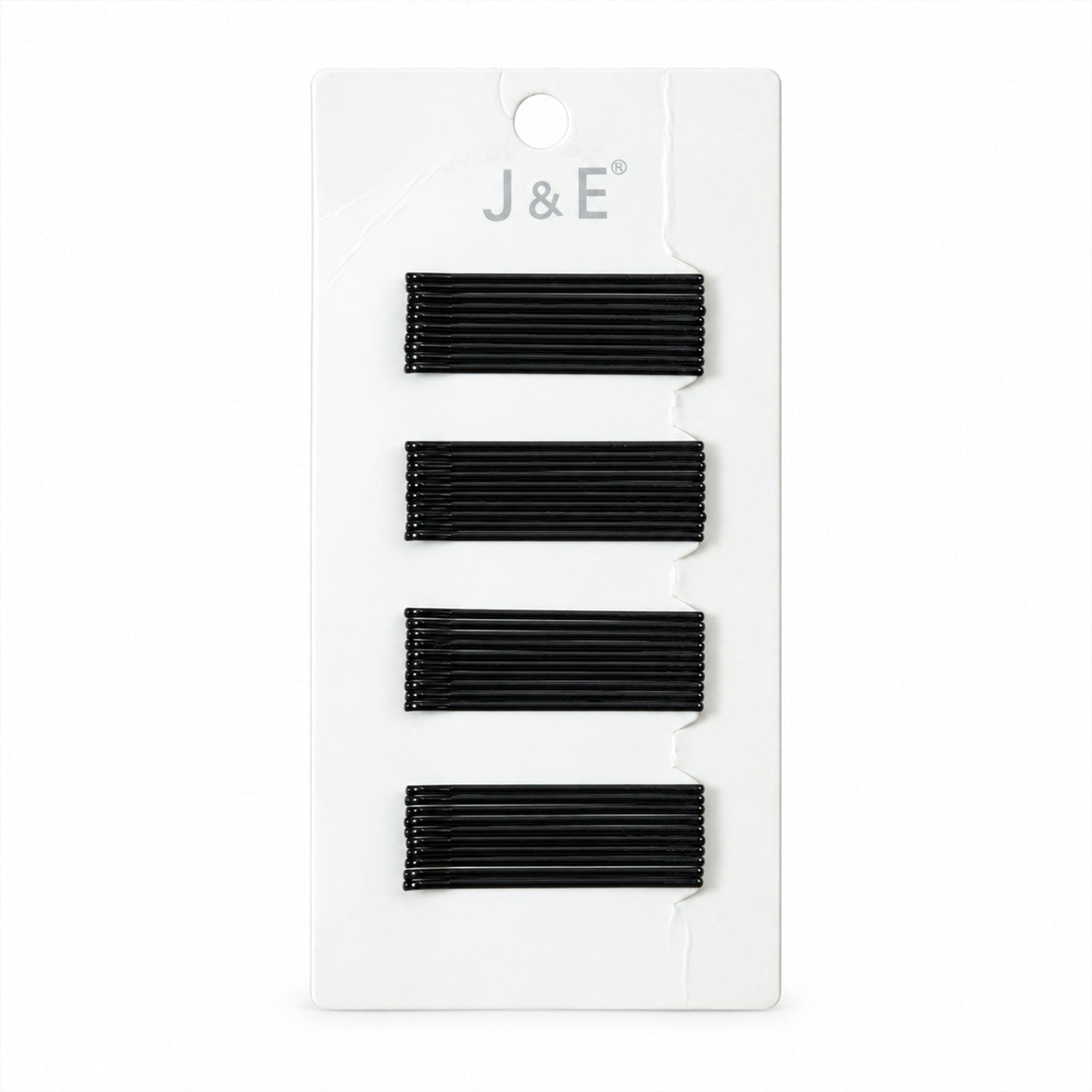 A black bobby pin is measured at approximately 6 cm on a light brown background.