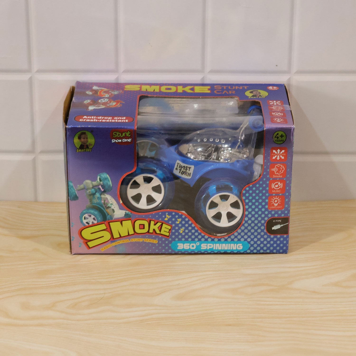 The blue remote control stunt car in its retail packaging, featuring product details and graphics.