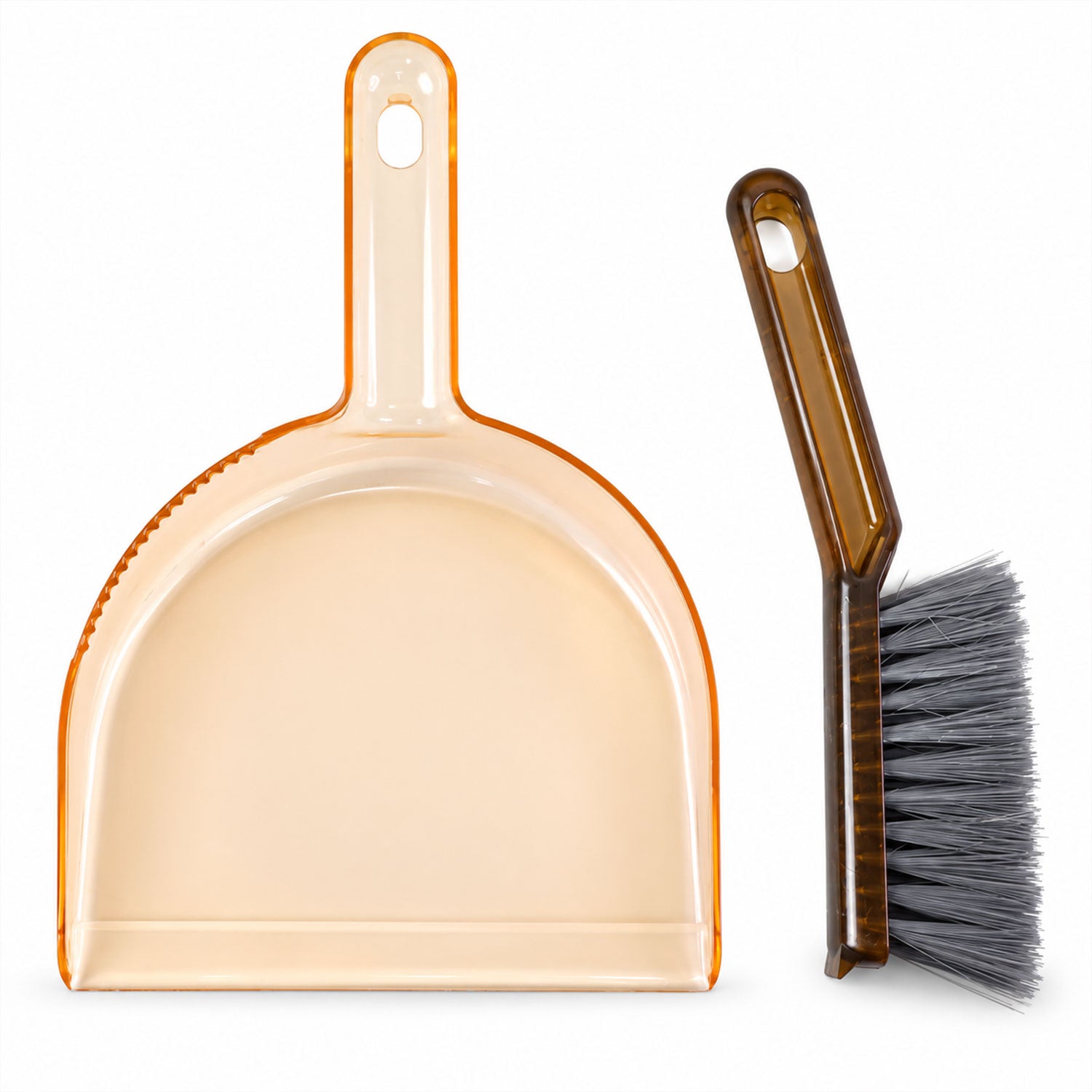 An amber plastic dustpan and a dark brown hand brush with gray bristles are arranged side by side on a plain white