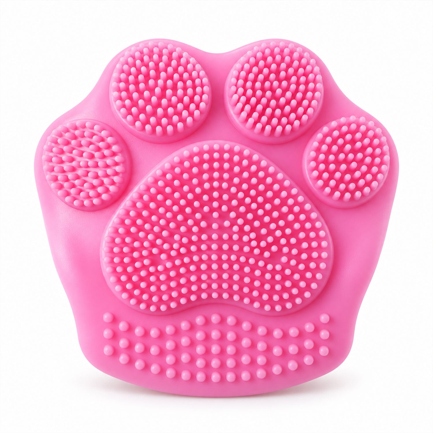 A bright pink paw-shaped facial scrubber with numerous silicone bristles is centered on a white background.