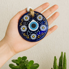 Evil eye charm hanging in a car, protecting the driver