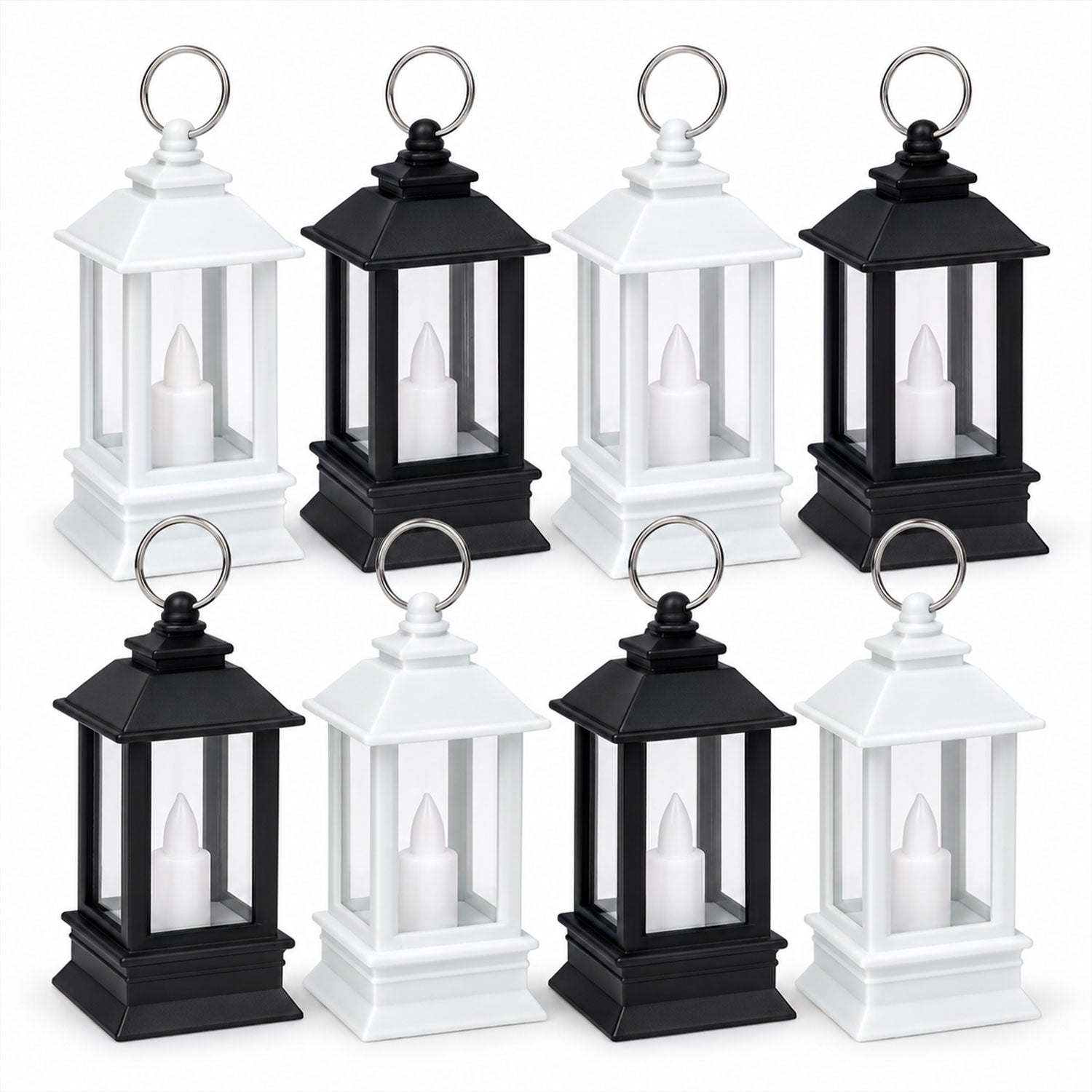 Eight miniature lanterns, four black and four white, each containing a white LED candle, are arranged in two rows on a plain