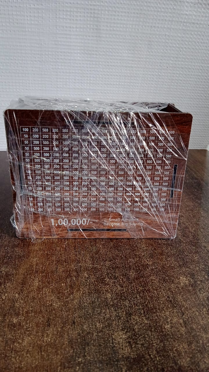 Wooden piggy bank money box placed on table in room setting