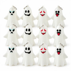 Twelve unlit white ghost figures with four different expressive faces and silver hanging rings are arranged in rows.