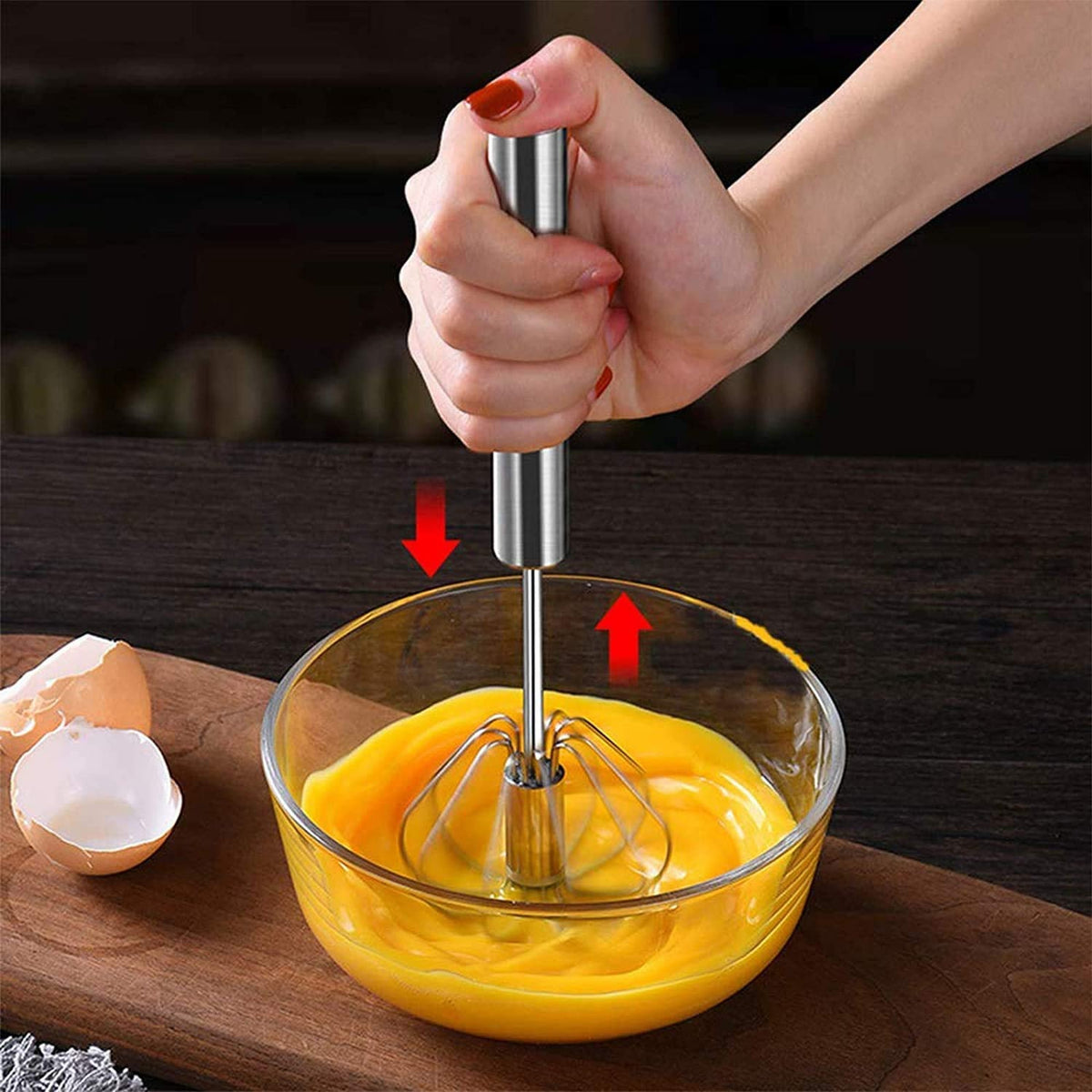Small stainless steel hand push rotary egg whisk for kitchen use.