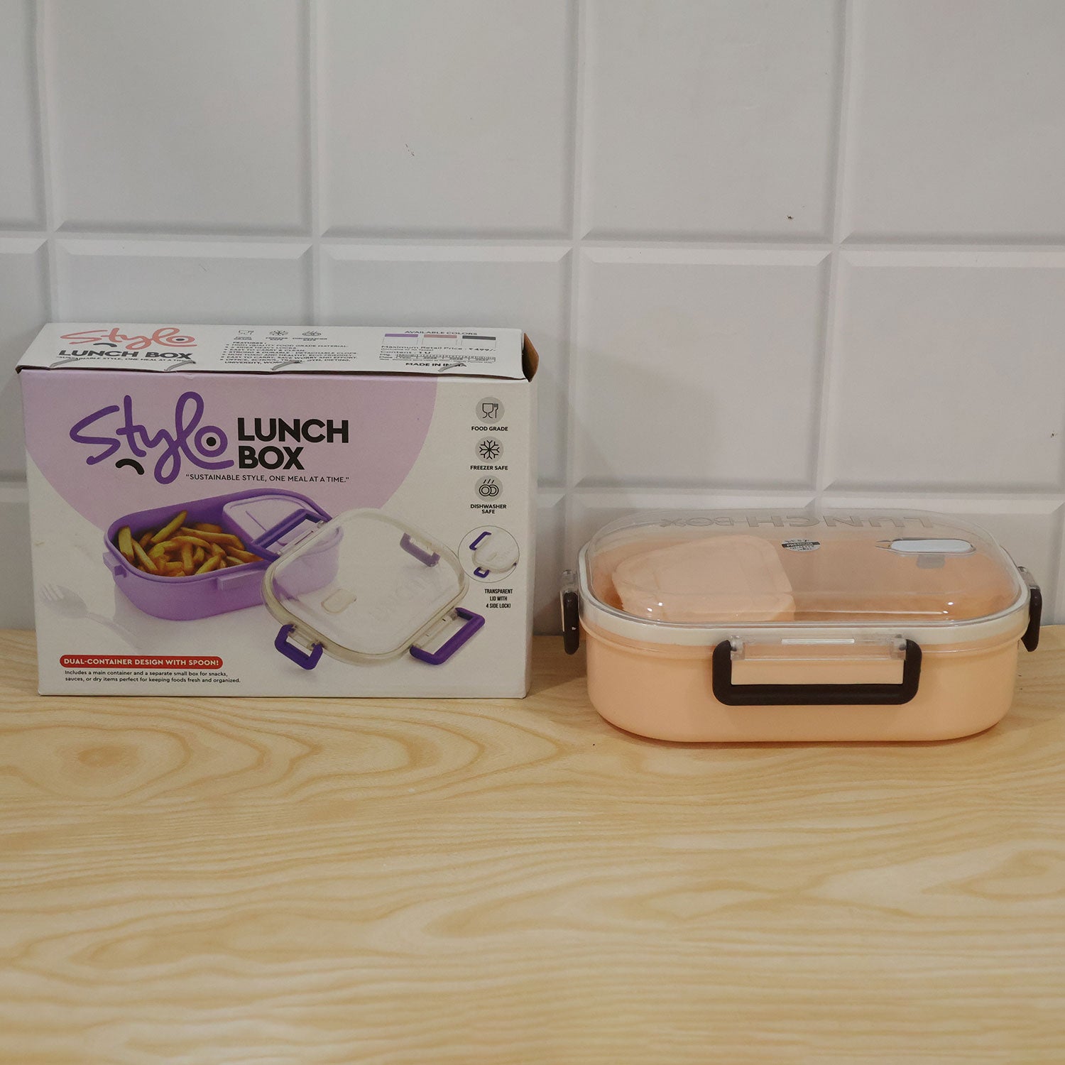 Two compartment plastic lunch box with spoon, showing compact size