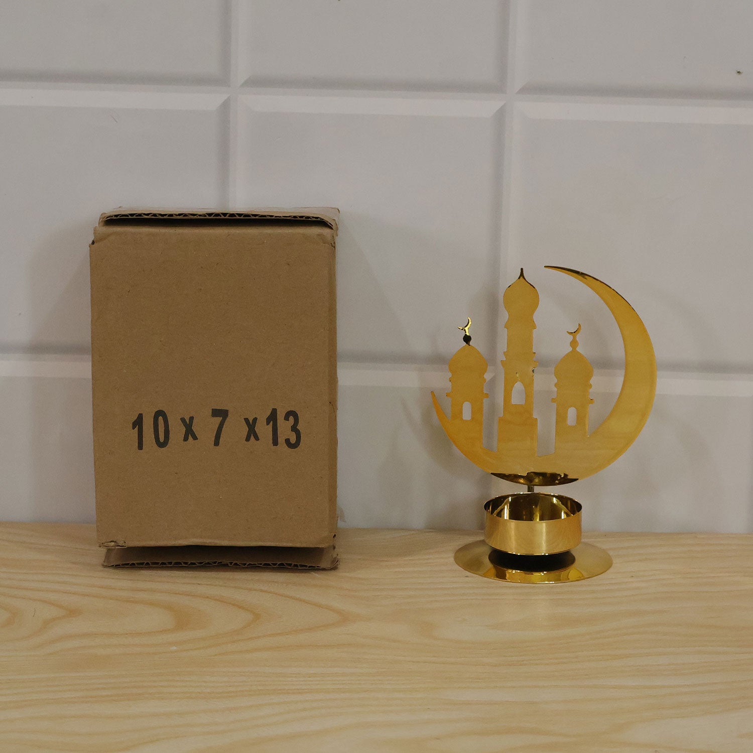 Golden metal crescent mosque incense holder on a table display