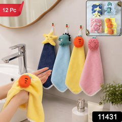 A person drying hands with a yellow carrot-shaped towel, with three other colorful animal-shaped towels hanging on â€“ view 2