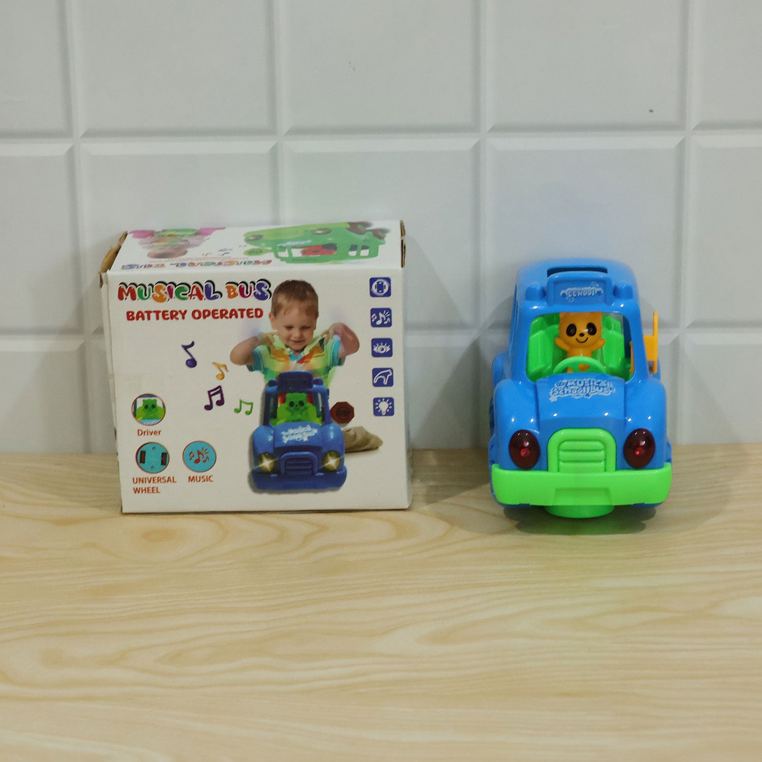 Musical school bus toy from a lower angle, emphasizing its size and details.