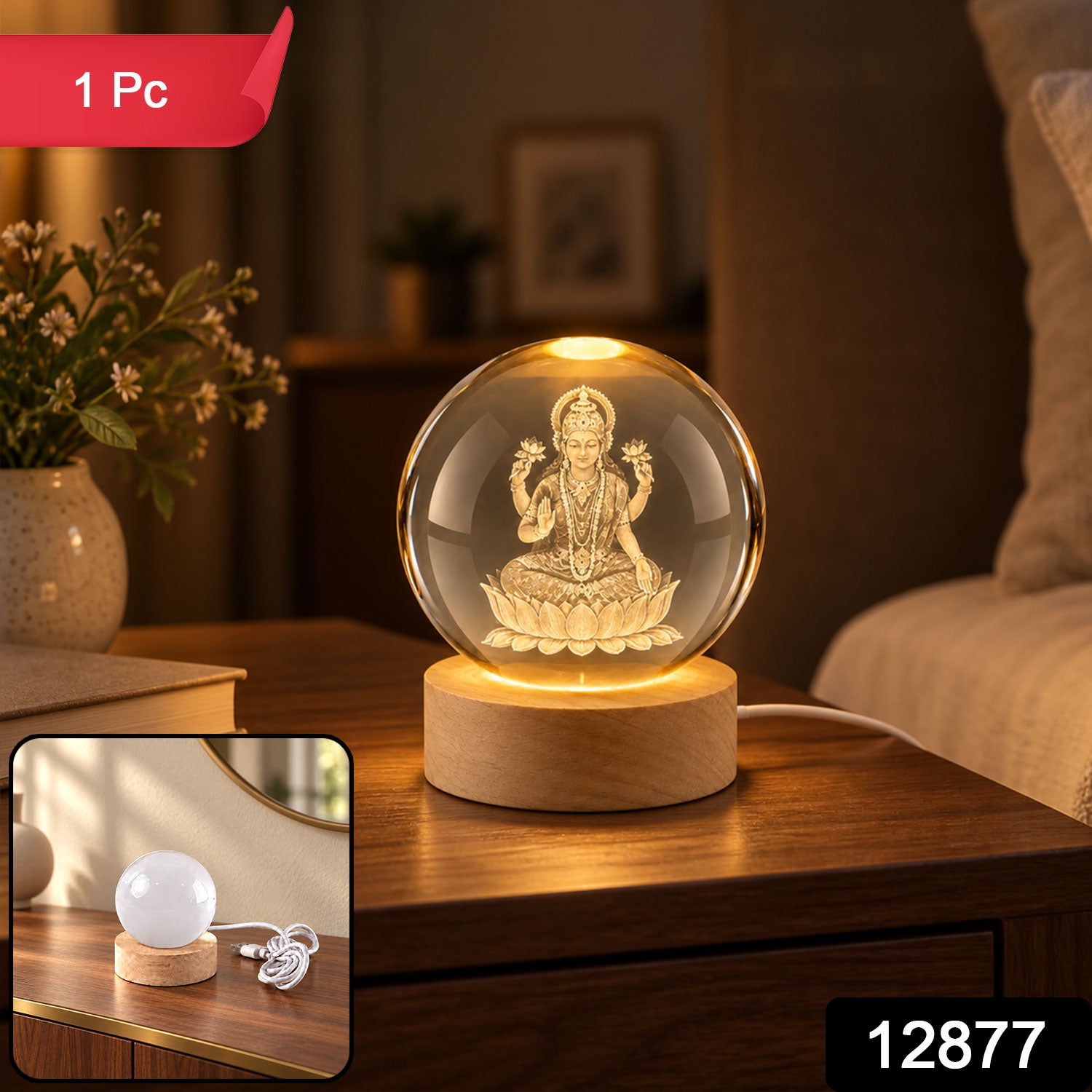 A crystal ball lamp featuring a glowing Laxmi figure, positioned on a light wooden stand, casting a warm glow.