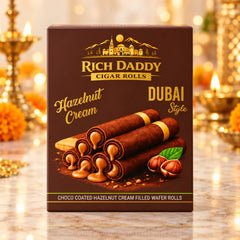Close-up of a brown box of hazelnut cream cigar rolls with a festive background.