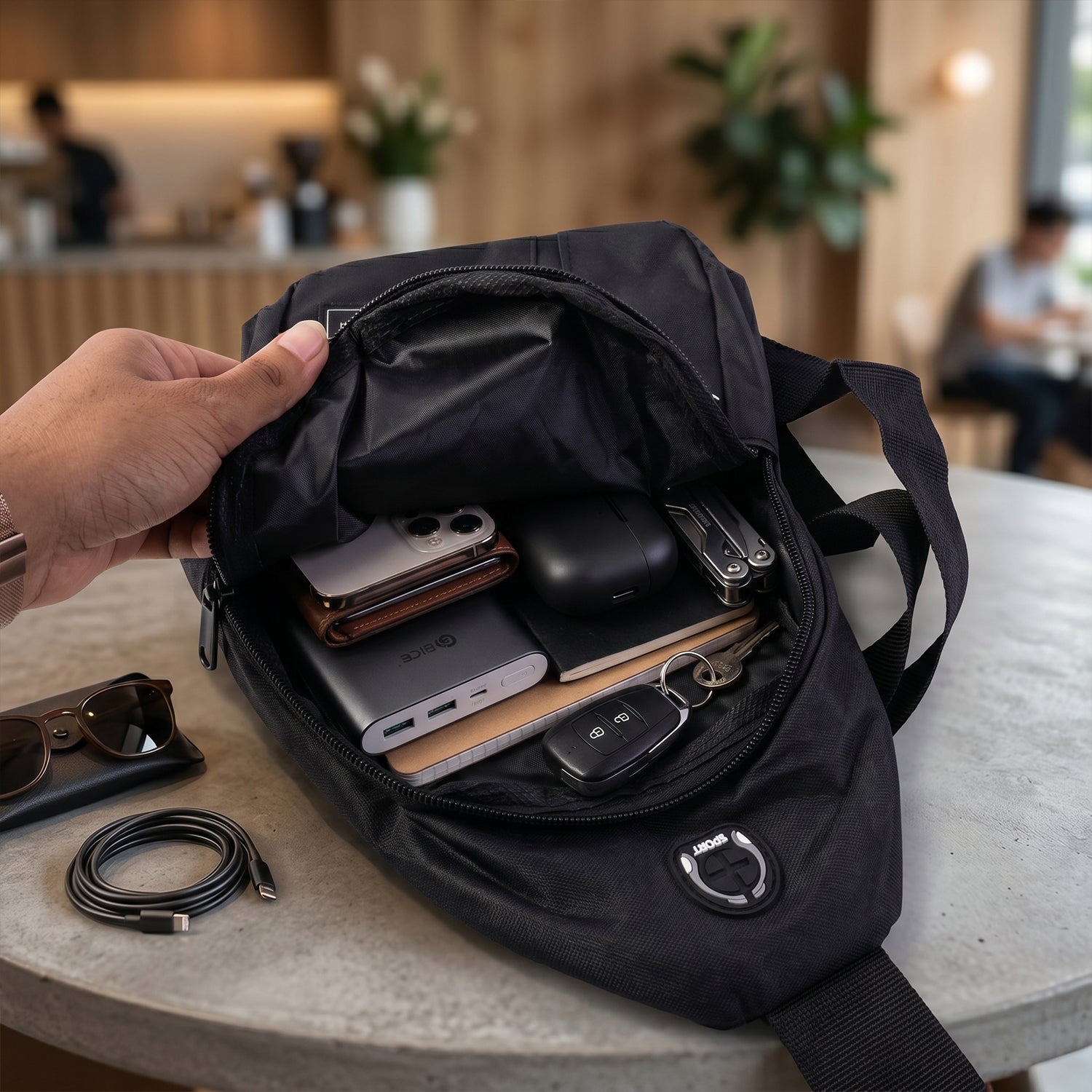 Waterproof sling bag with multiple compartments open