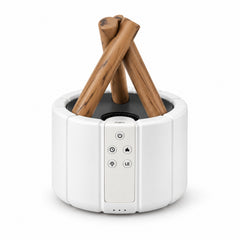 White humidifier with faux wood logs and control panel visible, shown on a plain white background.