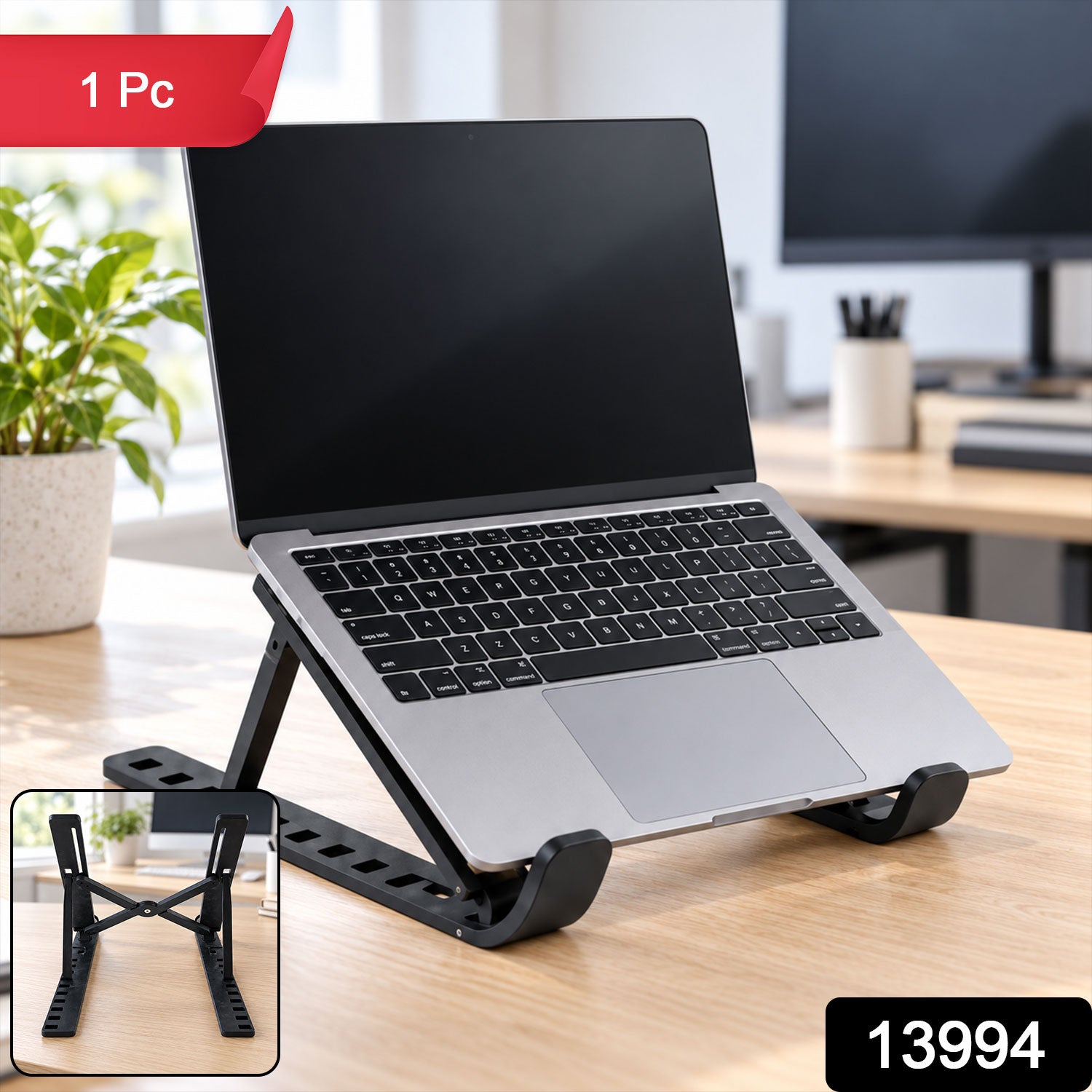 A silver laptop on a black adjustable stand sits on a wooden desk, with a small inset showing the stand folded.