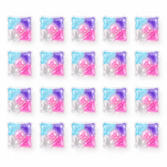 Twenty individual multi-colored laundry detergent pods are arranged in four rows of five on a plain white surface.