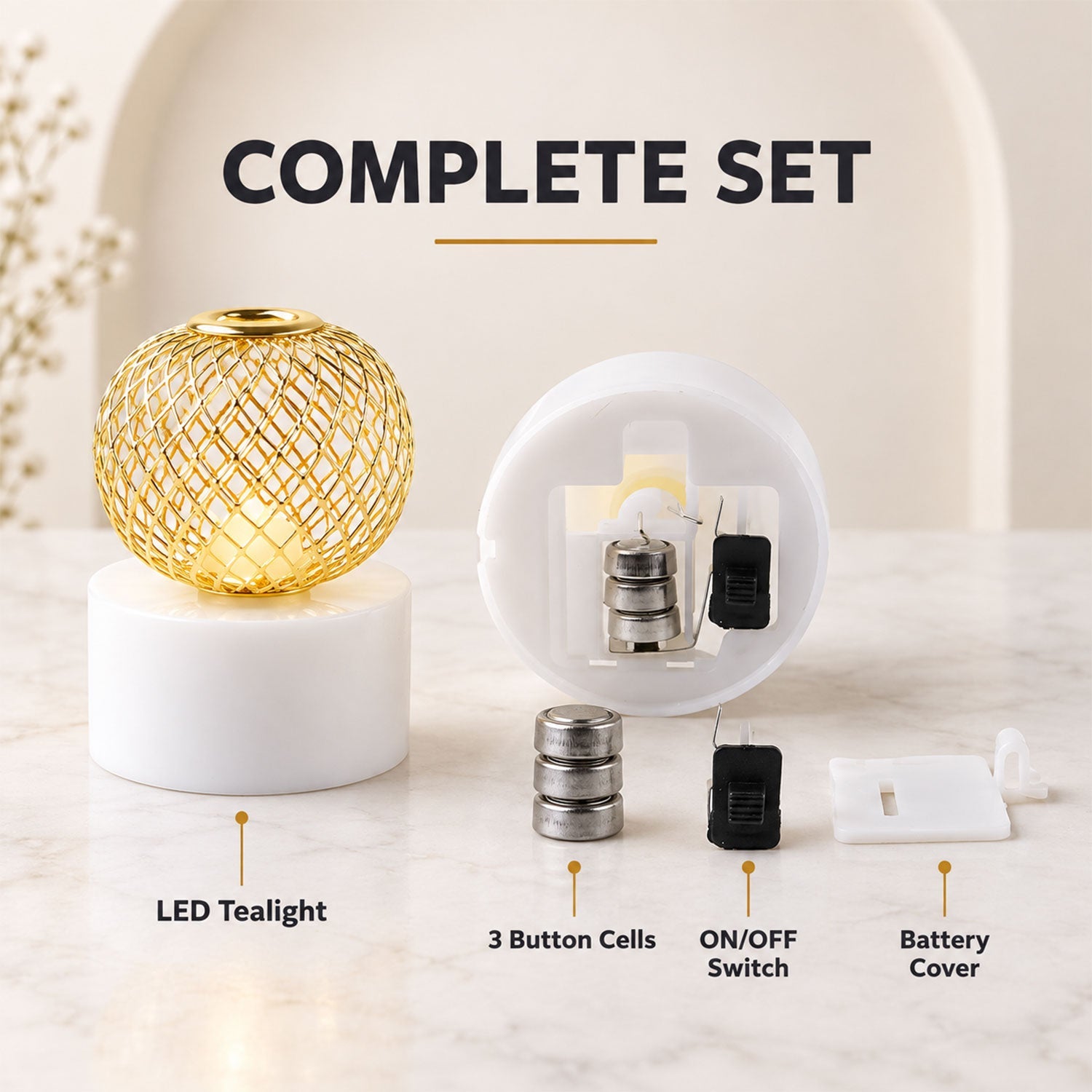 A gold mesh LED tealight disassembled, showing the base, battery, switch, and cover components.