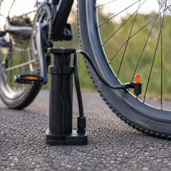 Mini foot pump inflating a football and bicycle tire