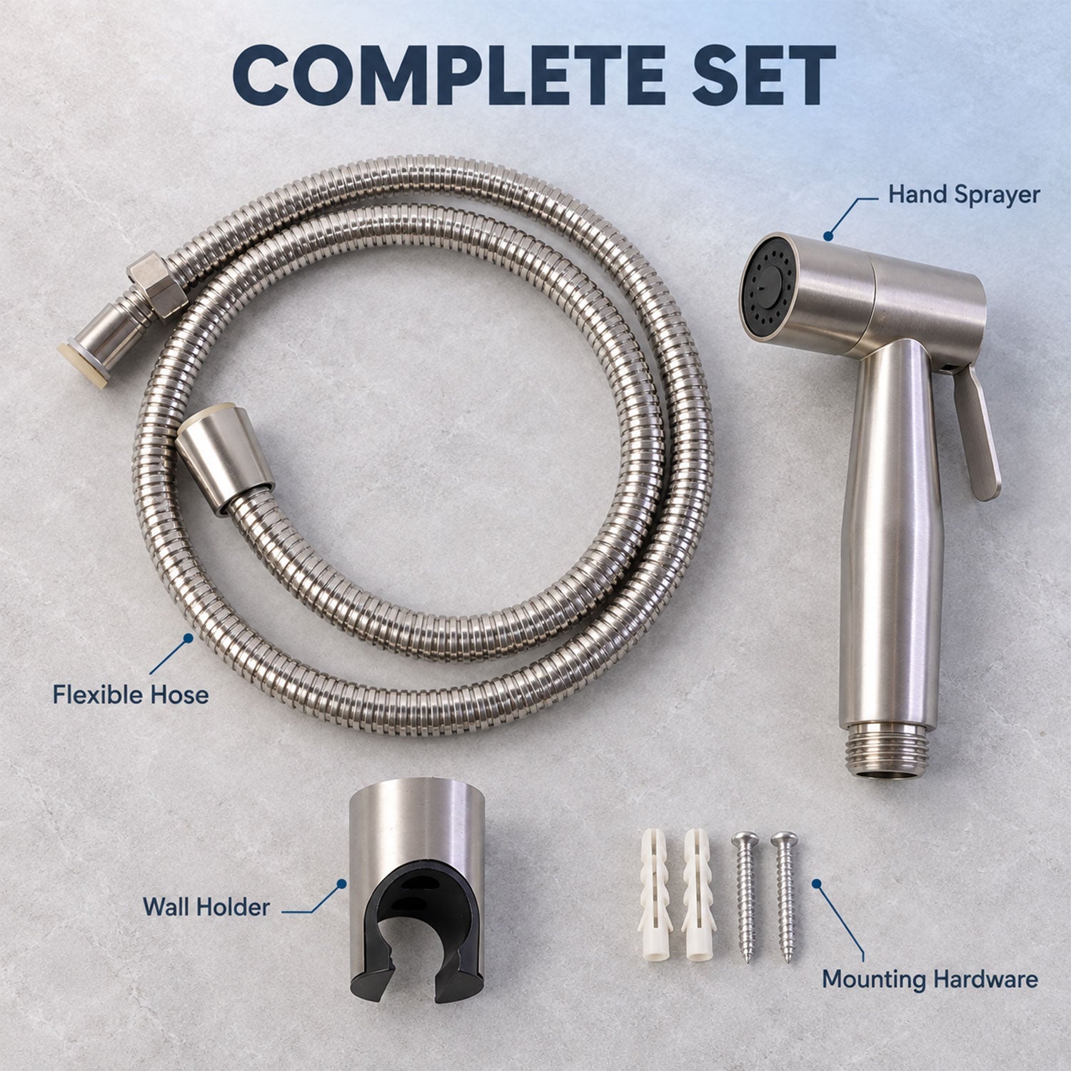 The complete set of a hand sprayer, flexible hose, wall holder, and mounting hardware is laid out on a gray surface with