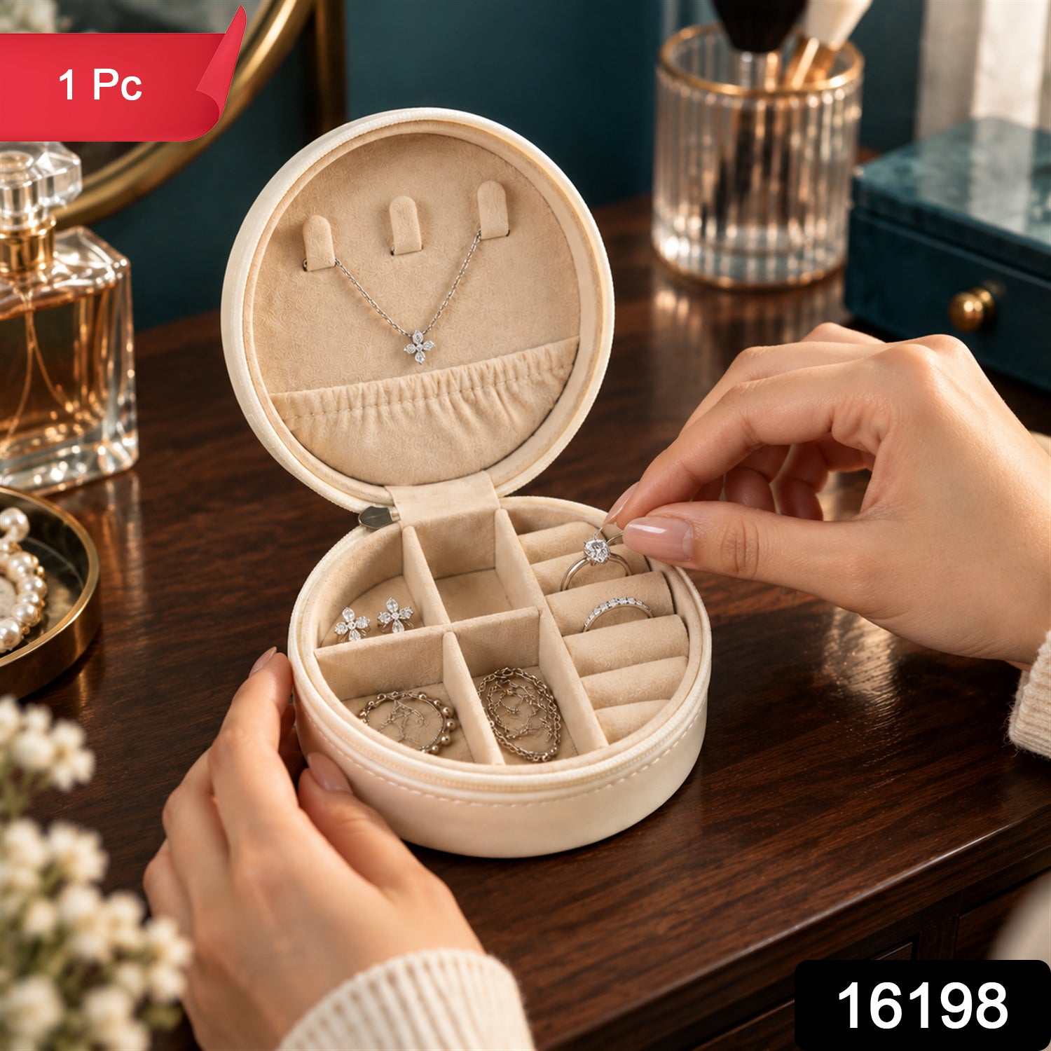 A person's hands placing a silver ring with a clear stone into a cream-colored round jewellery box with a red "1 Pc" label.