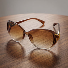 Stylish oversized sunglasses for women with gradient tinted lenses and gold temple details.